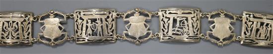 An Egyptian? white metal belt, pierced and decorated with scarabs and figures, 93cm.